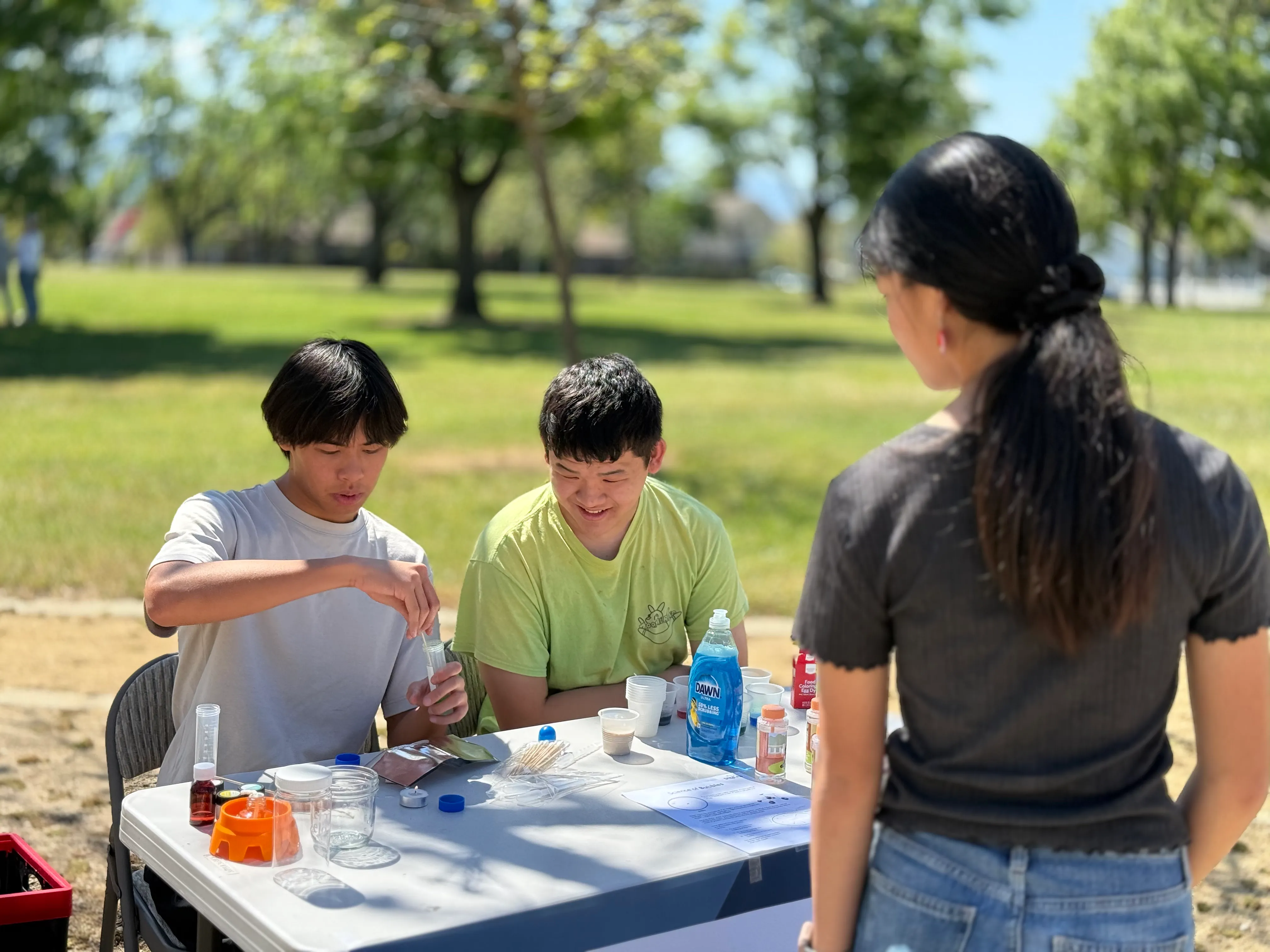 Two students conduct a hands-on chemistry experiment at Lonehill Park.