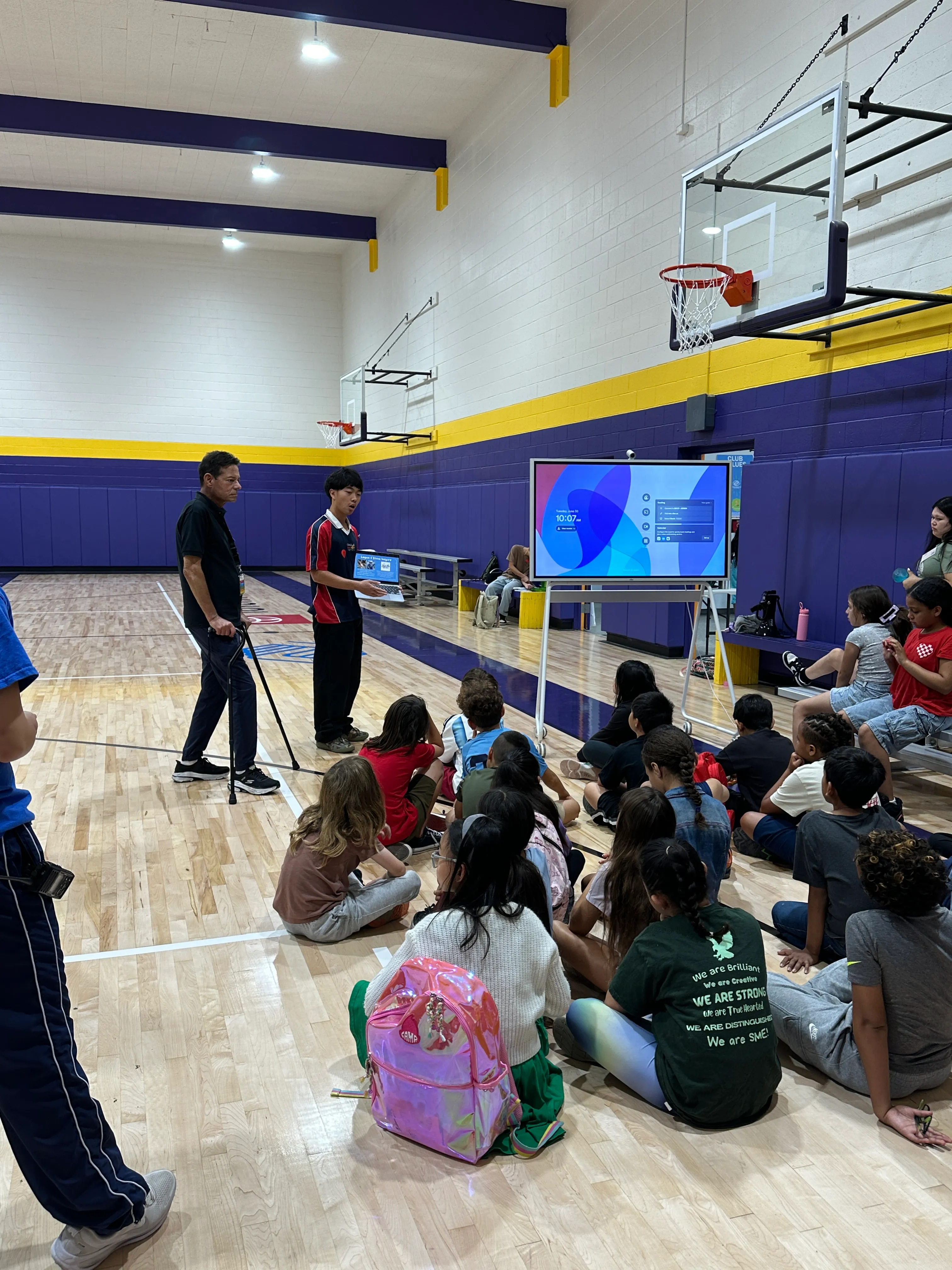 Logan Chow demonstrates the intricate anatomy of the human hand to young learners.